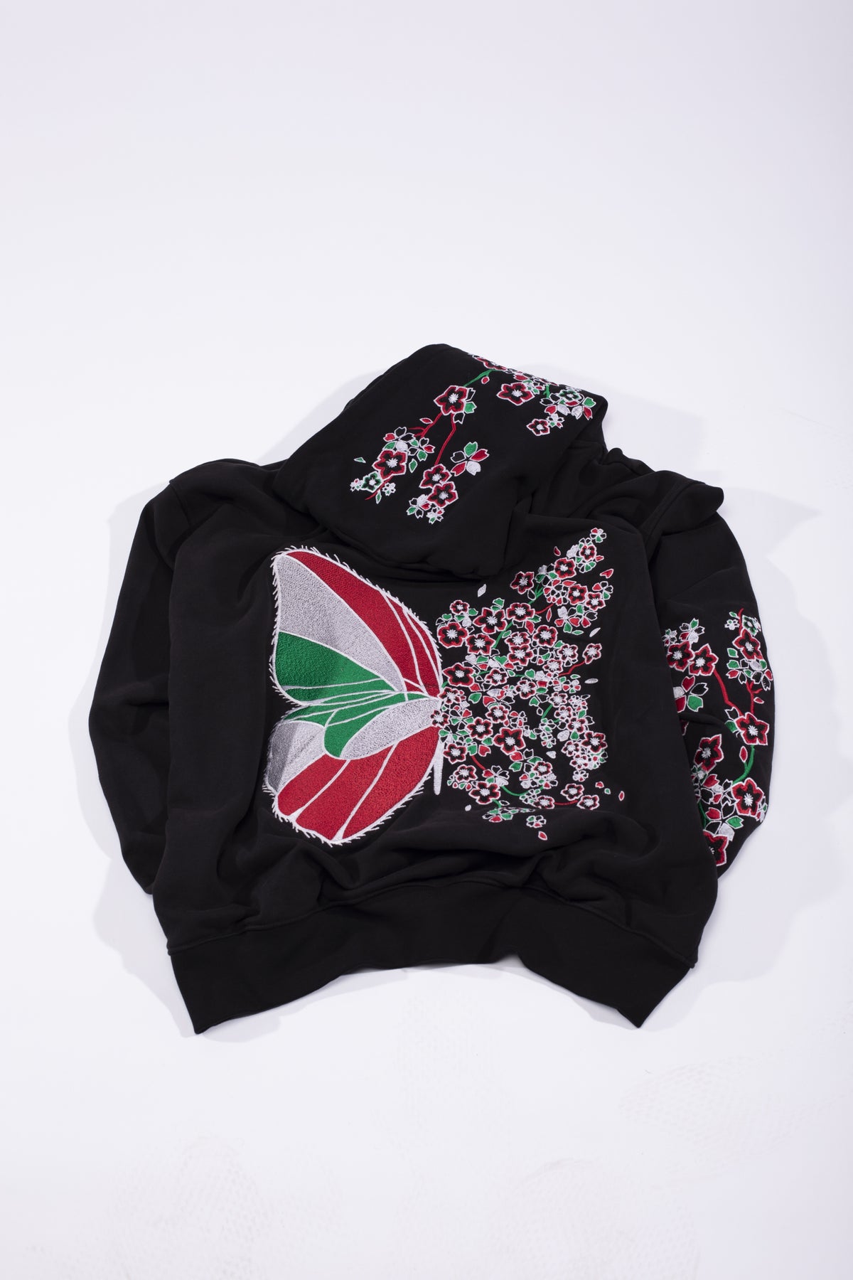 Farasha Hoodie: black hoodie with an embroidered butterfly in Lebanese colours and cascading Palestinian poppies (view 2)