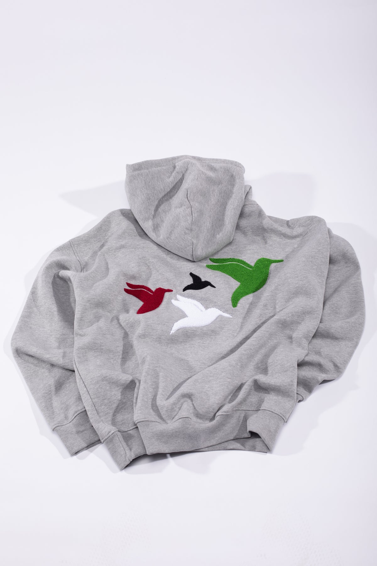 Sirb Hoodie: grey hoodie with four textured embroidered doves in red, black, white and green (view 3)