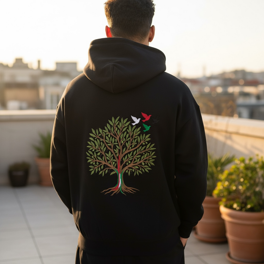 Zaytoun Hoodie: black hoodie with an embroidered olive tree, flag-coloured trunk and birds in flight